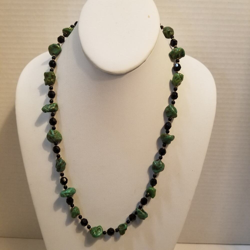 Twenty two inch imitation green turquoise with black spacer beads and faceted